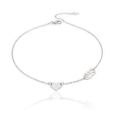 Silver bracelet with heart and paw print charms on a white background