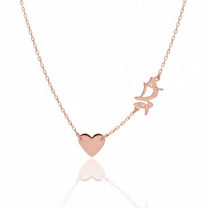 Rose gold necklace with heart and butterfly pendant on a white background