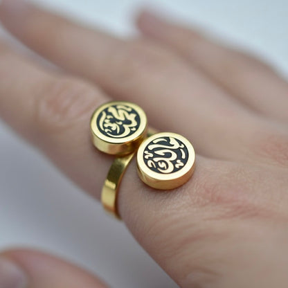 Gold rings with Arabic calligraphy on a hand