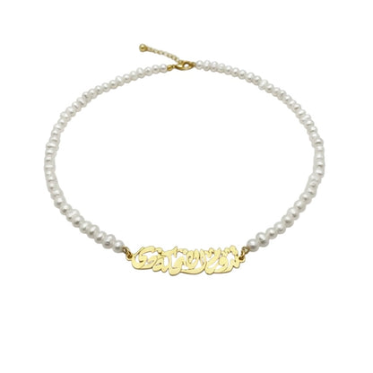 Pearl necklace with a gold nameplate on a white background