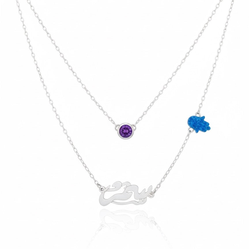 Silver necklace with purple and blue gemstones on a white background