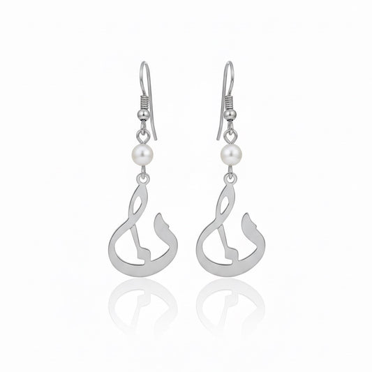 Silver earrings with pearl drops on a white background