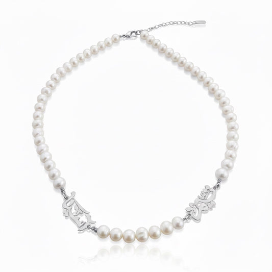 Pearl necklace with silver clasp on a white background